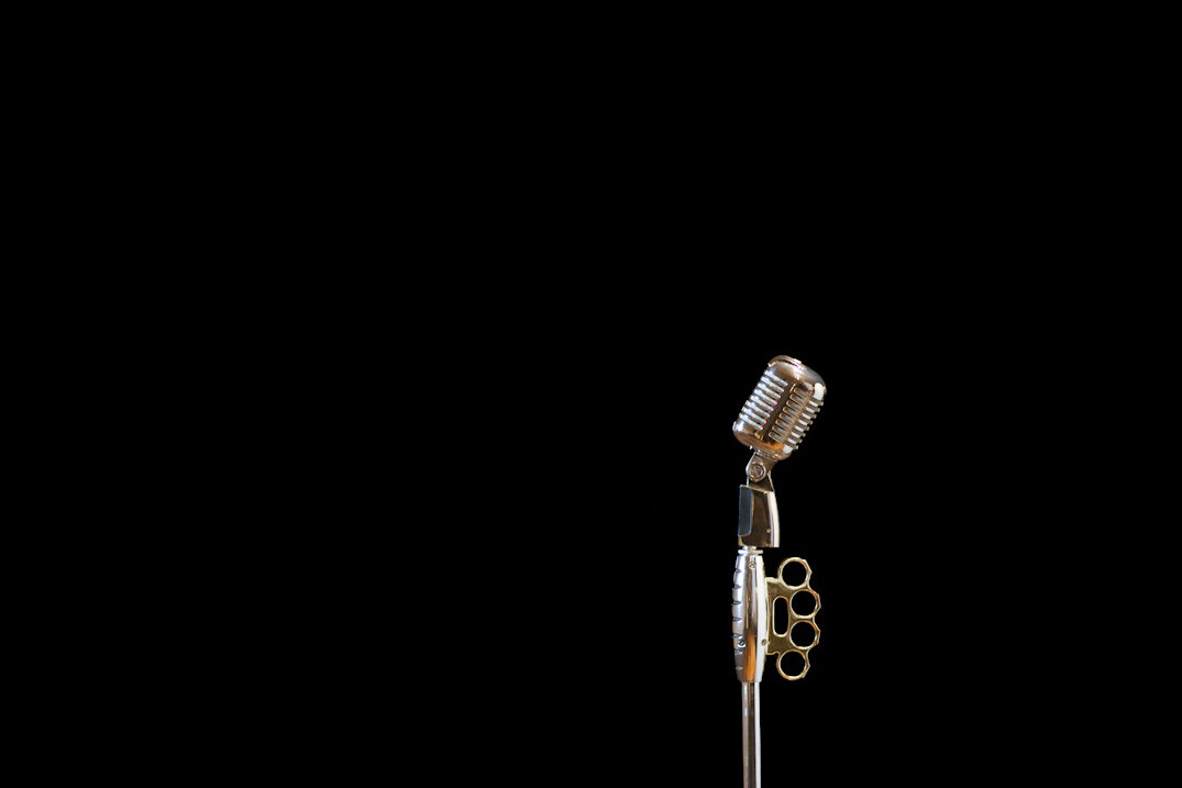 Microphone on a stand in front of an empty stage